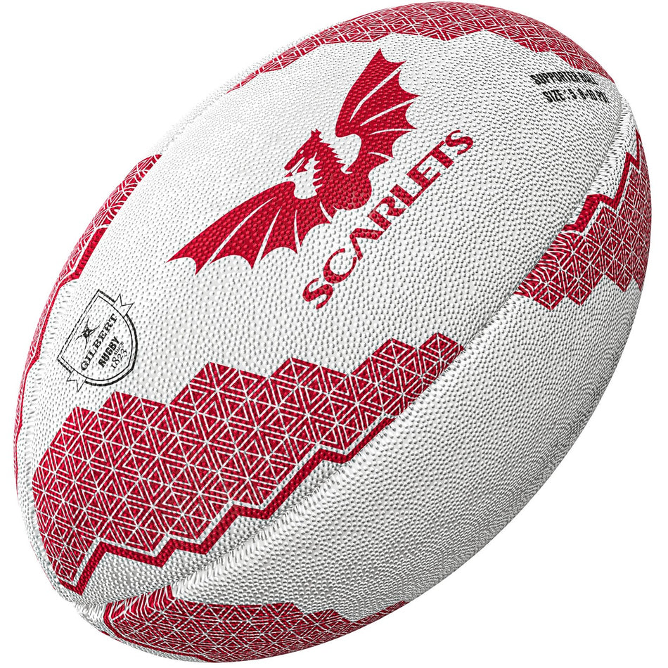The Gilbert Scarlets Supporters Rugby Ball features a white base, red geometric patterns, a red dragon graphic, and "Scarlets" printed on the side—ideal for any Scarlets fan or to mark the United Rugby Championship.