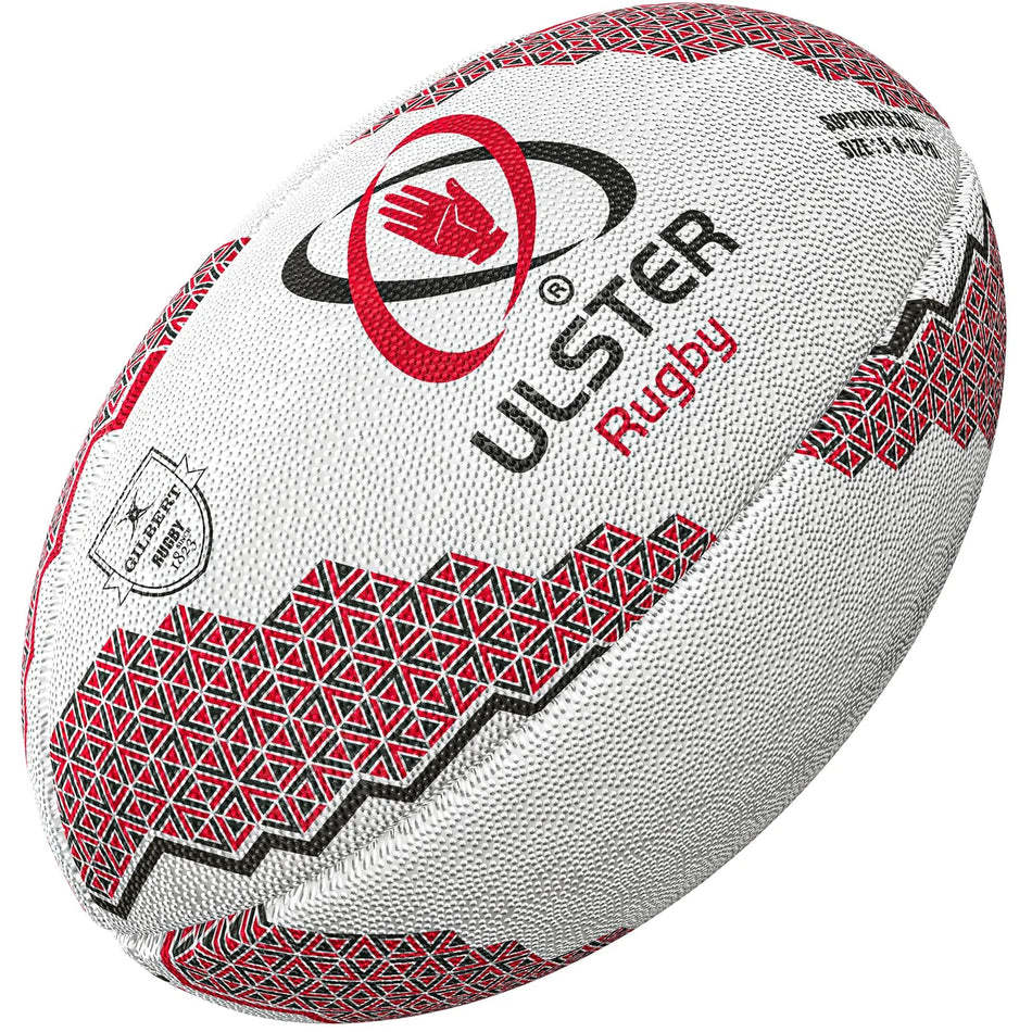 The Gilbert Ulster Supporters Rugby Ball features red and black geometric patterns, the Ulster Rugby logo, and text. Shown angled on a white background, it’s ideal for any Ulster rugby fan. Brand: Gilbert.