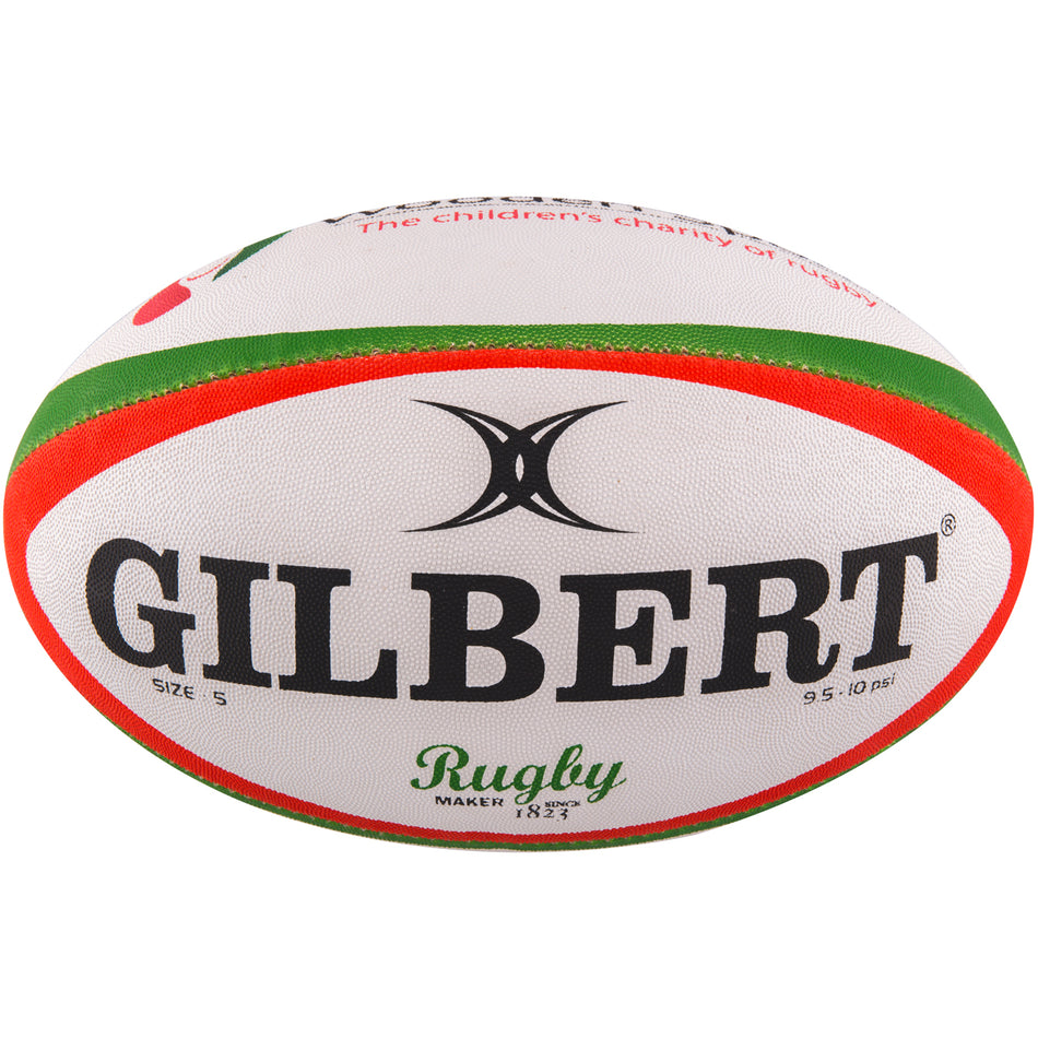 The Gilbert Wooden Spoon Rugby Ball is white with green and red stripes, featuring the bold black Gilbert logo and "Rugby" in green script—a great choice for charity support.