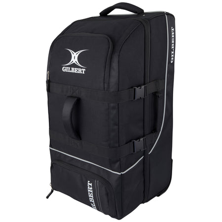 The black Gilbert Club Tour Wheeled Holdall is a large sports bag with handles, zippered compartments, side straps, wheels, and the Gilbert logo printed in white on the front and side.