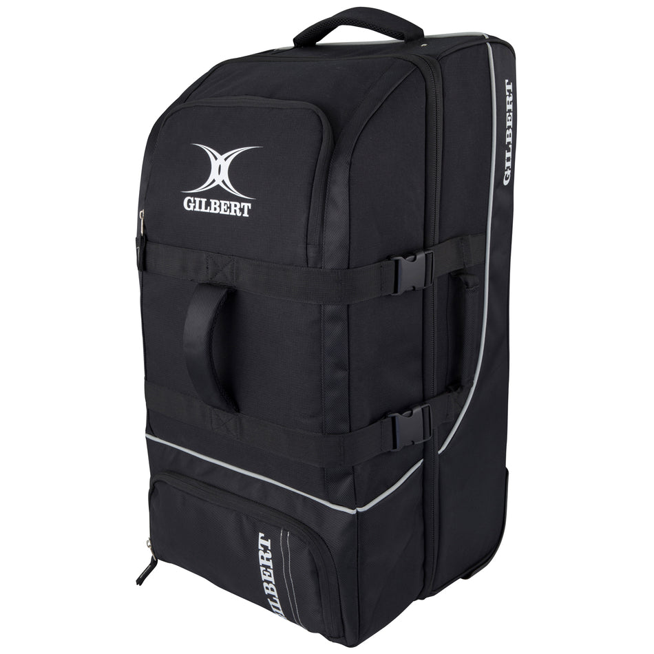 The black Gilbert Club Tour Wheeled Holdall is a large sports bag with handles, zippered compartments, side straps, wheels, and the Gilbert logo printed in white on the front and side.