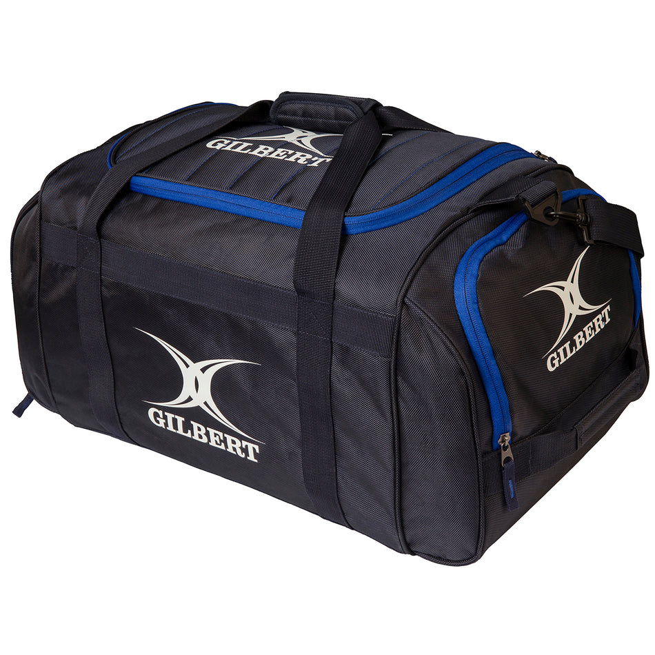 The Gilbert Performance Holdall is a large black kit bag with blue accents and sturdy handles, displaying the white Gilbert brand name and logo on the side and top.