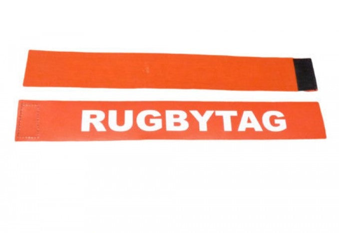 The Carta Sport Rugby Tag Belt set includes two orange fabric tags—one printed with "RUGBYTAG" in white and one blank—plus a Velcro belt, all displayed flat on a white background.