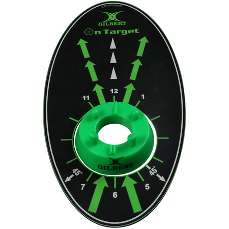 The Gilbert Kicking Mat by Gilbert is an oval-shaped black and green mat with white arrows, degree markings, and a green circular centerpiece designed to help improve rugby kicking accuracy during training.