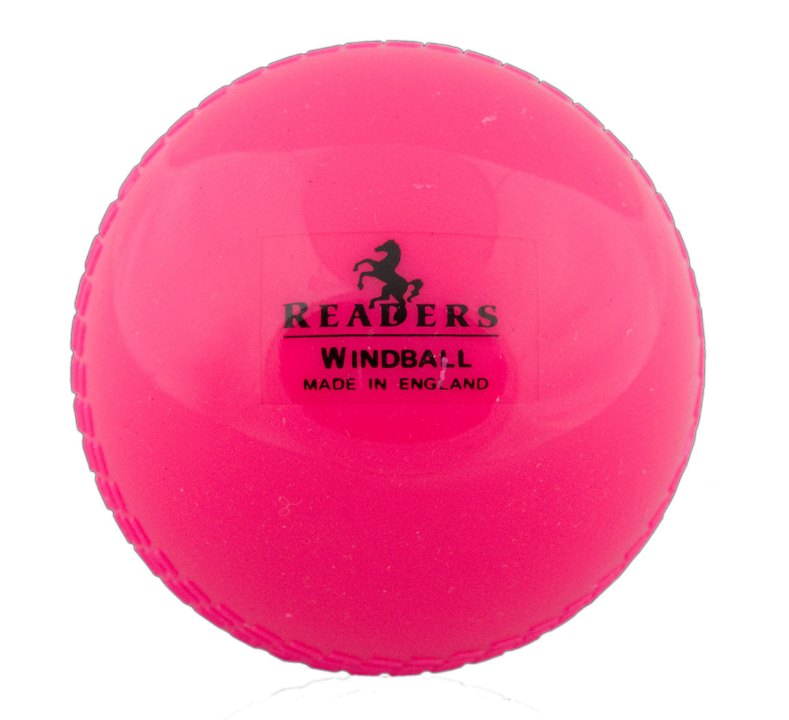 The Readers Windball is a bright pink cricket ball by Readers, featuring visible seam lines and ideal for Kwik Cricket coaching. Its label shows "READERS WIND BALL MADE IN ENGLAND" below a horse logo.