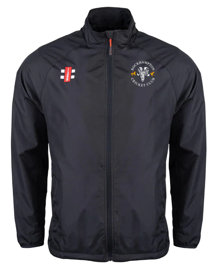 The Gray Nicolls Rockhampton CC Velocity Rain Jacket - Junior is black with a high collar, featuring the club logo on the left chest and a small red and white emblem on the right. Water repellent for staying dry on and off the field.