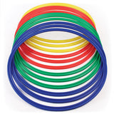 The Martin Berrill Sports Flat Hoop - Set of Twelve features durable activity hoops in red, yellow, green, and blue, stacked in overlapping layers against a white background.