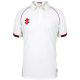 The Corse & Staunton CC Matrix V2 Short Sleeve Match Shirt by Martin Berrill Sports is a white cricket shirt with maroon sleeve and shoulder trim, a small red and black left chest logo, and moisture-wicking fabric to keep you cool.