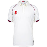 The Hatherley & Reddings CC Matrix V2 Short Sleeve Match Shirt by Martin Berrill Sports is white with maroon sleeve trim and piping, a collar, a red and black logo on the left chest, and moisture-wicking fabric for comfort.