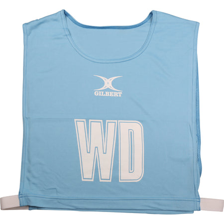 The Gilbert Netball Bibs in Sky feature large white "WD" letters on the front, the Gilbert brand name above them, and are made from breathable polyester for comfort during play.