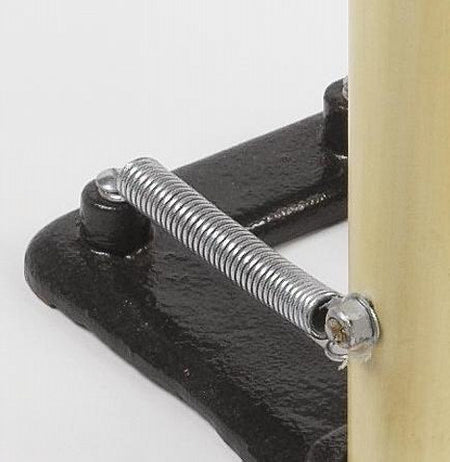 Close-up of the Martin Berrill Sports Replacement Spring for Spring Back Stumps, secured with screws between a black metal base and vertical beige rod for sturdy, reliable stump action.