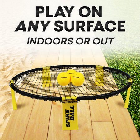 The Kankakee Spikeball Standard Set rests on a wooden surface, perfect for any outdoor sports game.