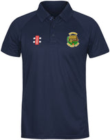 The Gray Nicolls Stanway CC Matrix V2 Polo Shirt is navy blue with a collar, three buttons, "Cricket Club" logo on the left chest, a small red and white emblem on the right, and moisture-wicking fabric for training comfort.