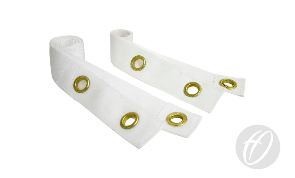 Two Harrod Sport Vinyl Coated Net Centre Tape strips with gold metal grommets are shown on a white background, rolled at one end and laid out diagonally, with a gray circular logo in the bottom right corner.