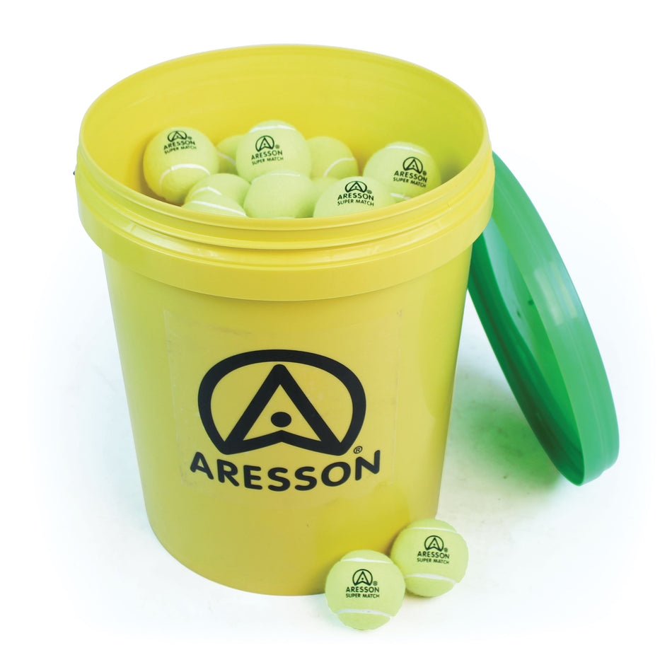 The Aresson Super Match Tennis Balls - 60 Ball Bucket features a yellow bucket with green lid, filled with high-quality, non-pressurised Aresson tennis balls, plus a few branded balls placed outside on a white surface.