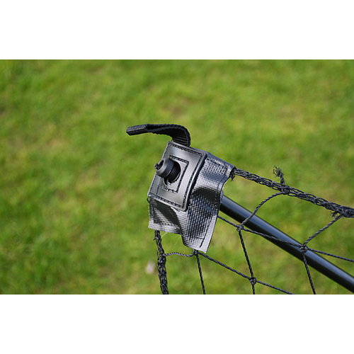 Close-up of the Precision Training Quick Setup Portable Rebounder (5ft x 3ft)—a black net secured with a plastic and fabric fastener to a metal pole, set against grassy background—highlighting its easy and fast assembly.