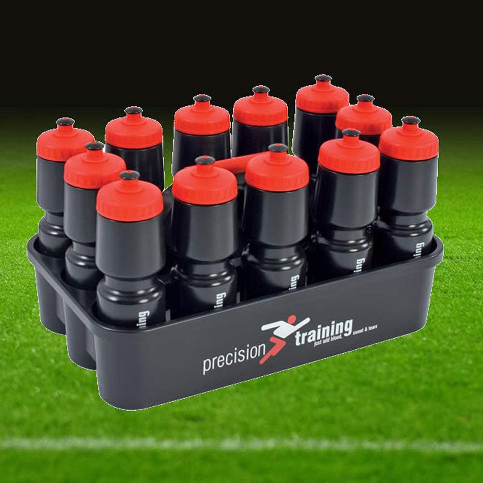 The Precision Training Water Bottles & Carrier Black holds twelve 750ml bottles with red caps, branded with the Precision Training logo, displayed on a grass soccer field.