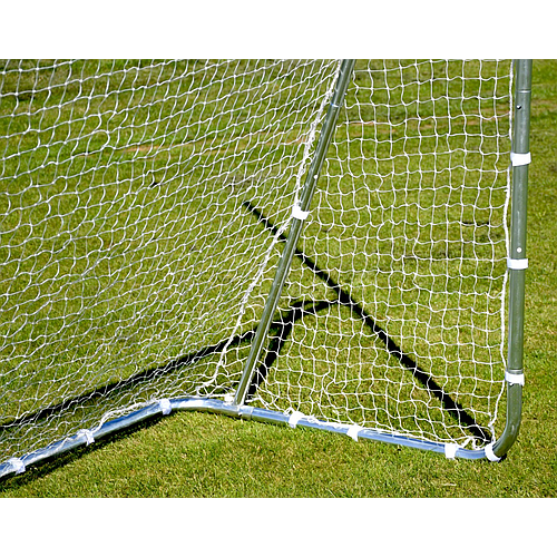 Close-up of a Precision Training Precision Multi Sport Steel Goal’s zinc-coated steel frame with white netting on green grass, sunlight casting shadow of the frame and net onto the ground.