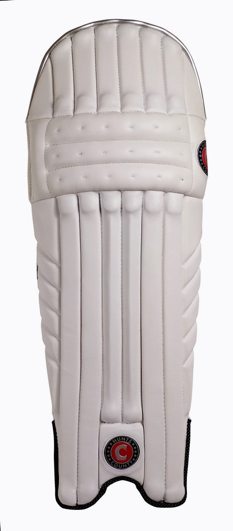 The Hunts County Tekton Senior Batting Pad is a single white leg guard with vertical padding and high-density foam, displaying two round red and black Hunts County logos, photographed against a plain white background.