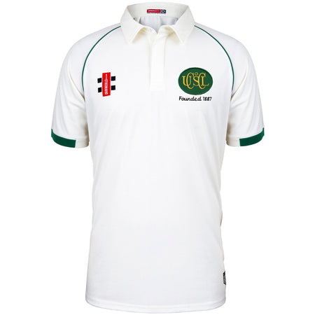 The Upton St Leonards CC Matrix V2 Short Sleeve Match Shirt by Martin Berrill Sports is white with green trim on the collar and sleeves, featuring a red and black logo on the left chest and a green/gold club crest with "Founded 1867" on the right.