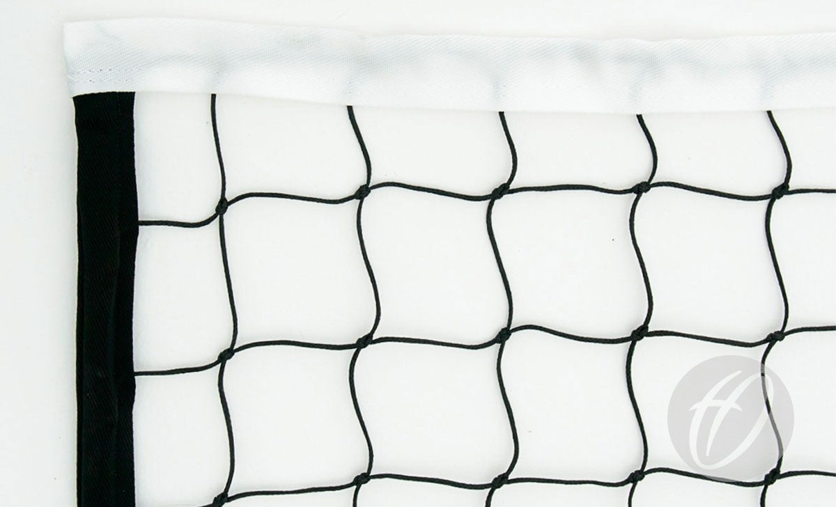 Close-up of the top corner of a Harrod Sport Supermatch Competition Volleyball Net, featuring black netting with white trim and evenly spaced squares, against a white background. A faint logo appears in the lower right corner.