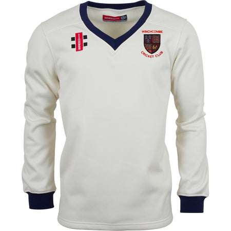 The Gray Nicolls Winchcombe CC Pro Performance Sweater is a white long-sleeve top with navy cuffs and collar, club logo on the left chest, two extra patches, and sport-specific fabric for comfort and durability.