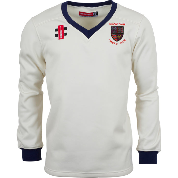 The Gray Nicolls Winchcombe CC Pro Performance Sweater is a white long-sleeve top with navy cuffs and collar, club logo on the left chest, two extra patches, and sport-specific fabric for comfort and durability.