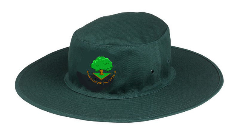 The Martin Berrill Sports Woodmancote CC Sun Hat is a dark green, wide-brimmed cricket hat featuring the club logo—a green tree above a yellow triangle with “Woodmancote Cricket Club”—embroidered on the front.
