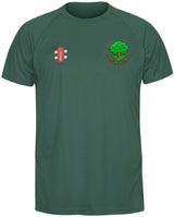 The Gray Nicolls Woodmancote CC Junior Matrix V2 T Shirt is a dark green, moisture-wicking top featuring a cricket equipment logo on the right chest and an embroidered Woodmancote CC crest with tree on the left chest.