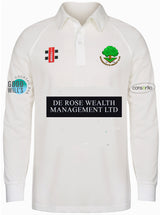 The Gray Nicolls Woodmancote CC Senior Matrix V2 Long Sleeve Shirt is a white cricket top with moisture wicking fabric, sponsor logos (“DE ROSE WEALTH MANAGEMENT LTD,” “GOODWILL’S,” “consortio”), and a green tree club logo on the chest.