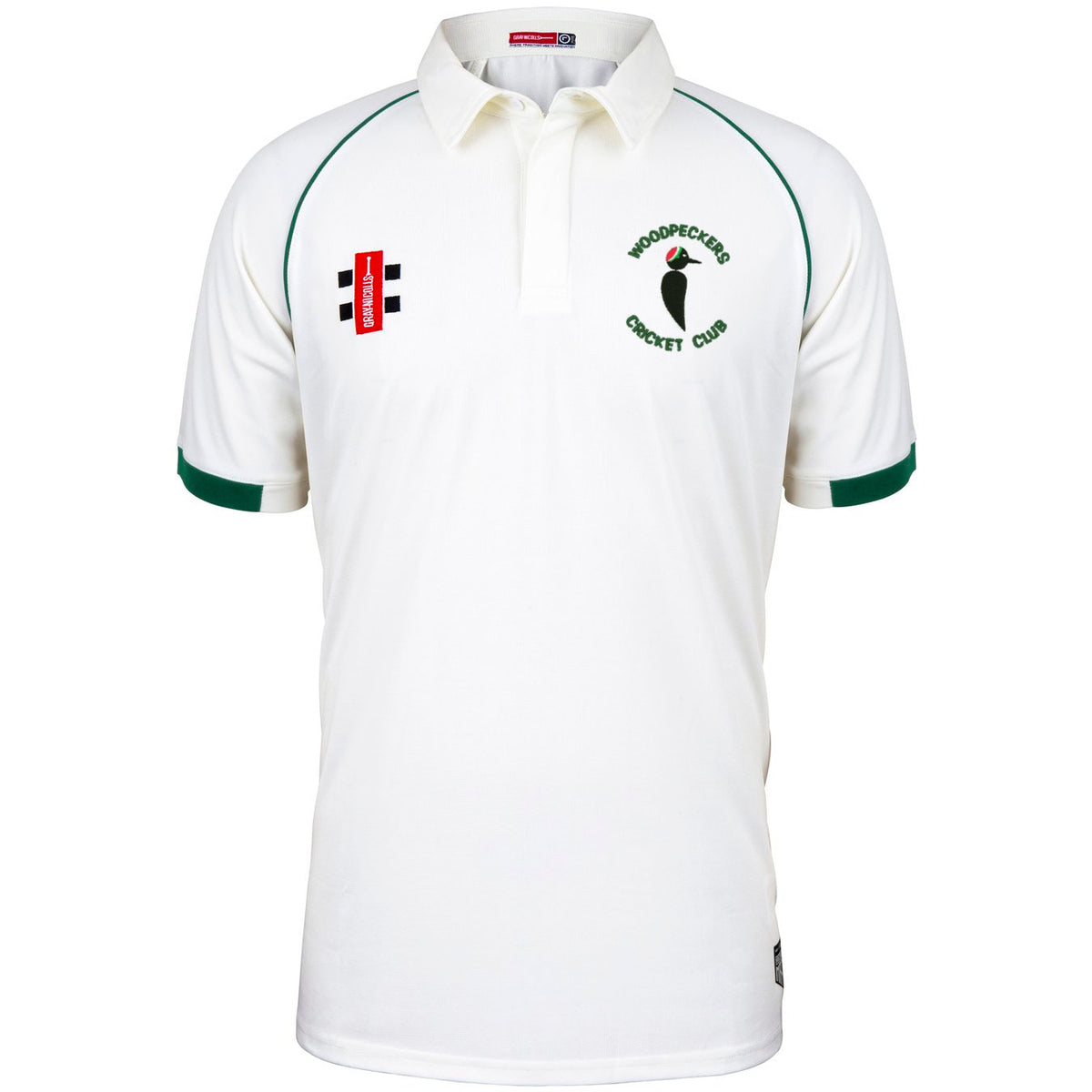 The Woodpeckers CC Matrix V2 Short Sleeve Match Shirt by Martin Berrill Sports is a white cricket shirt with green trim, moisture-wicking fabric, and embroidered logos for Woodpeckers Cricket Club and sponsors on the chest.