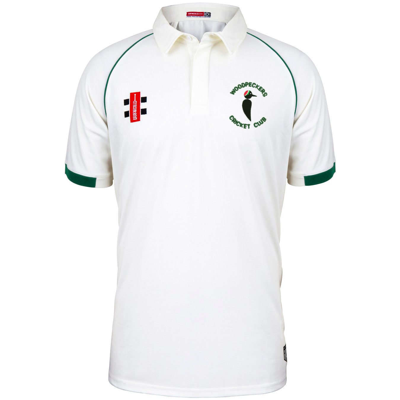 The Woodpeckers CC Matrix V2 Short Sleeve Match Shirt by Martin Berrill Sports is a white cricket shirt with green trim, moisture-wicking fabric, and embroidered logos for Woodpeckers Cricket Club and sponsors on the chest.
