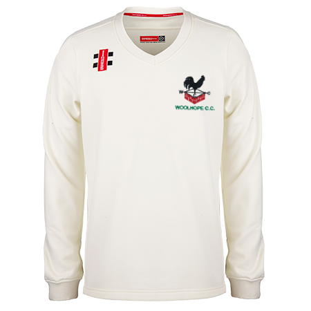 The Gray Nicolls Woolhope CC Pro Performance Senior Sweater is a cream V-neck long-sleeve with the Woolhope C.C. logo and a red sponsor patch on the chest.