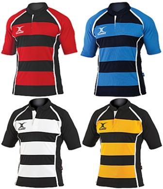 Four Gilbert Xact Match Hoop Shirts by Gilbert, each with horizontal stripes (red/black, blue/black, black/white, yellow/black), plus a white chest logo and trim on sides and shoulders. Lightweight and breathable sportswear.