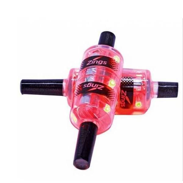 A close-up of two transparent pink Zings Backyard Zings - Flashing Cricket Bails intersecting at right angles, each with black handles and glowing red and green LED lights, just like the vibrant toys used in backyard cricket.