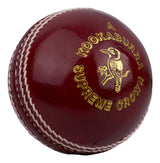 A red alum-tanned, hand-stitched Kookaburra Supreme Crown Cricket Ball with striking white stitching, a gold logo, and a kookaburra bird image.
