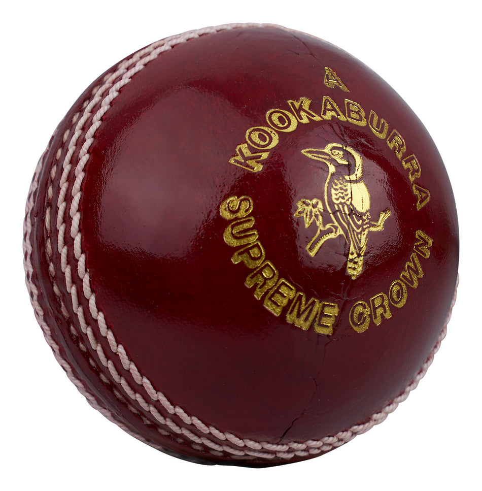 A red alum-tanned, hand-stitched Kookaburra Supreme Crown Cricket Ball with striking white stitching, a gold logo, and a kookaburra bird image.