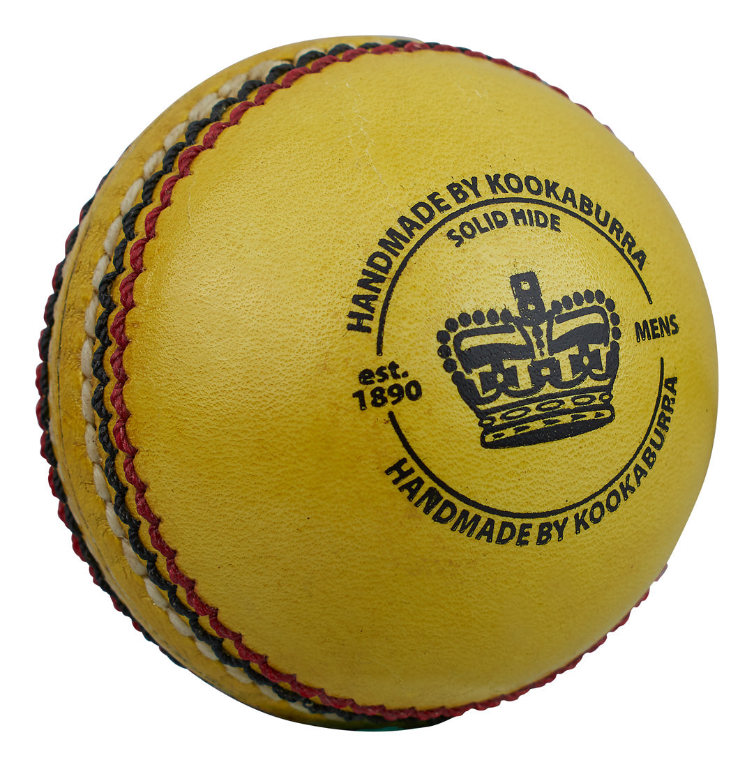The Kookaburra Indoor Club Cricket Ball is yellow, features a stitched seam, black text including "HANDMADE BY KOOKABURRA", "SOLID HIDE", "MENS", and "est. 1890", with a crown logo on its solid hide leather surface.