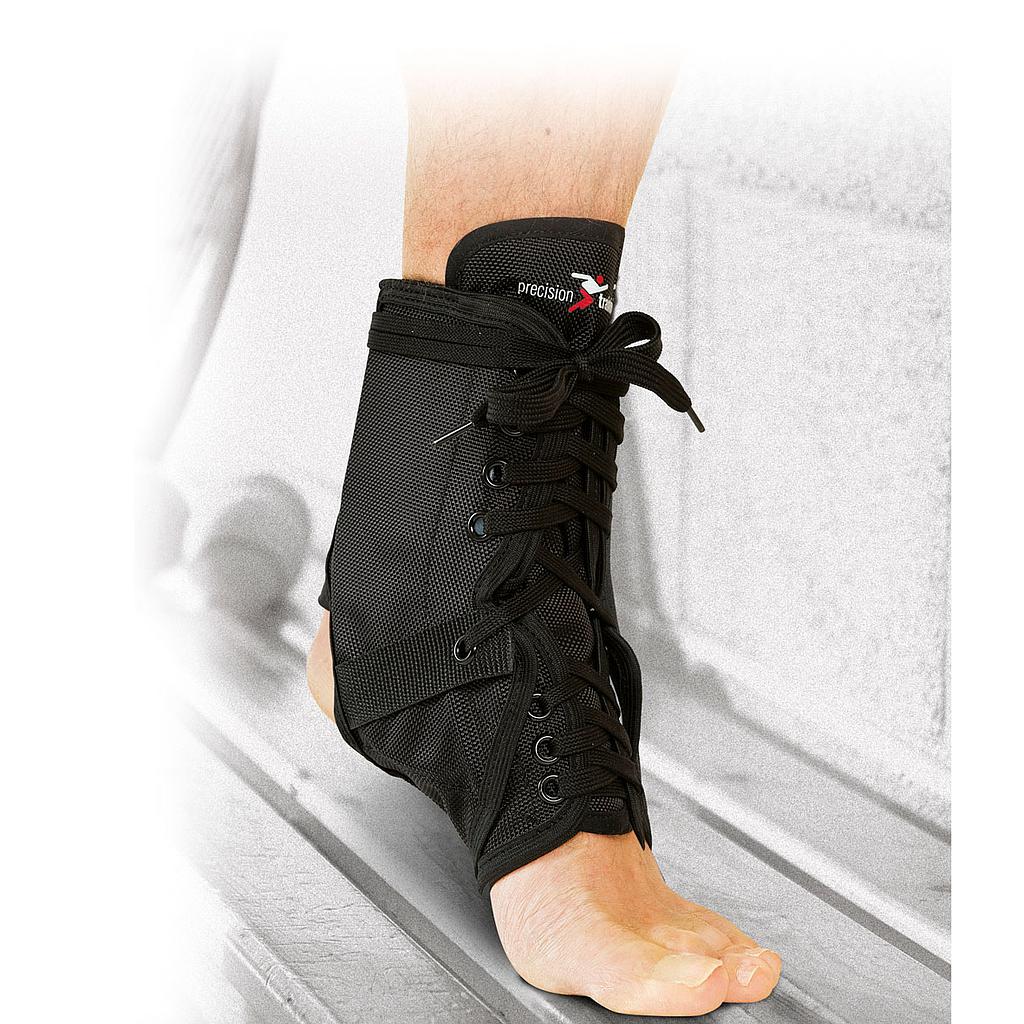 A person’s foot and lower leg wear the Precision Training Precision Neoprene Ankle Brace with Stays, a black lace-up support that exposes the toes and heel, shown against a light background.