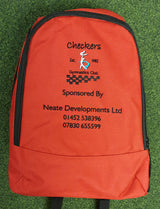 The PenCarrie Checkers Gymnastics Rucksack is a red 18L bag with embroidered club logo, sponsor details, and phone numbers in black and orange, plus a padded back panel, shown on green carpet.