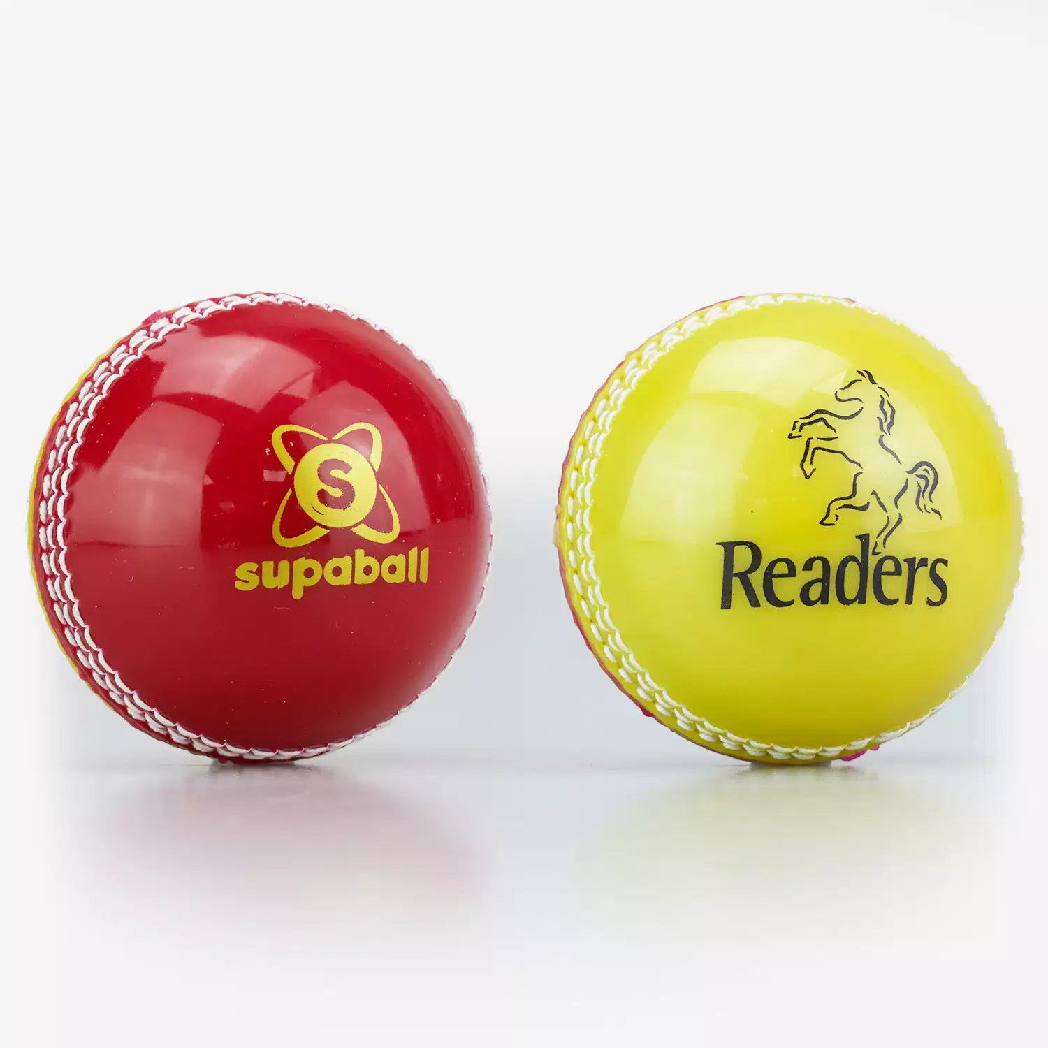 Two Readers Supaballs are shown side by side: the red ball on the left, ideal for coaching, shows its logo, while the yellow one on the right displays the Readers brand name and horse logo.
