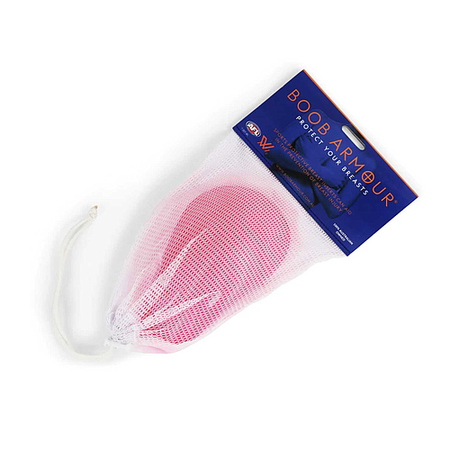 A pink Boob Armour Insert sits inside a white mesh drawstring bag with a blue label showing the Boob Armour brand name and "Protect Your Assets" slogan.