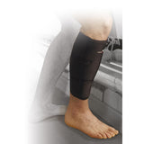 A person stands on a hard surface wearing a Precision Training Precision Neoprene Calf/Shin Wrap on their right leg, with adjustable compression for a secure fit. The left leg and background are partially faded out.