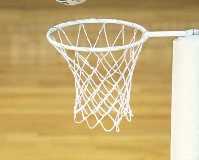 A close-up of a basketball above the hoop against a wooden court backdrop, highlighting net quality similar to Harrod Sport Competition White Netball Nets (Pair).