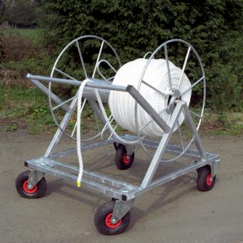 The Martin Berrill Sports Cricket Boundary Rope Trolley features a large white rope on a heavy duty galvanised steel frame with four red and black wheels, perfect for outdoor cricket boundary setup.
