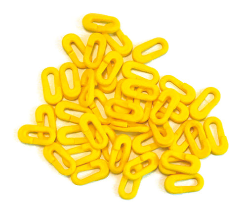 A pile of bright yellow, oval-shaped Precision Training Easyclips (Pack of 80), with flat sides, scattered on a white background.