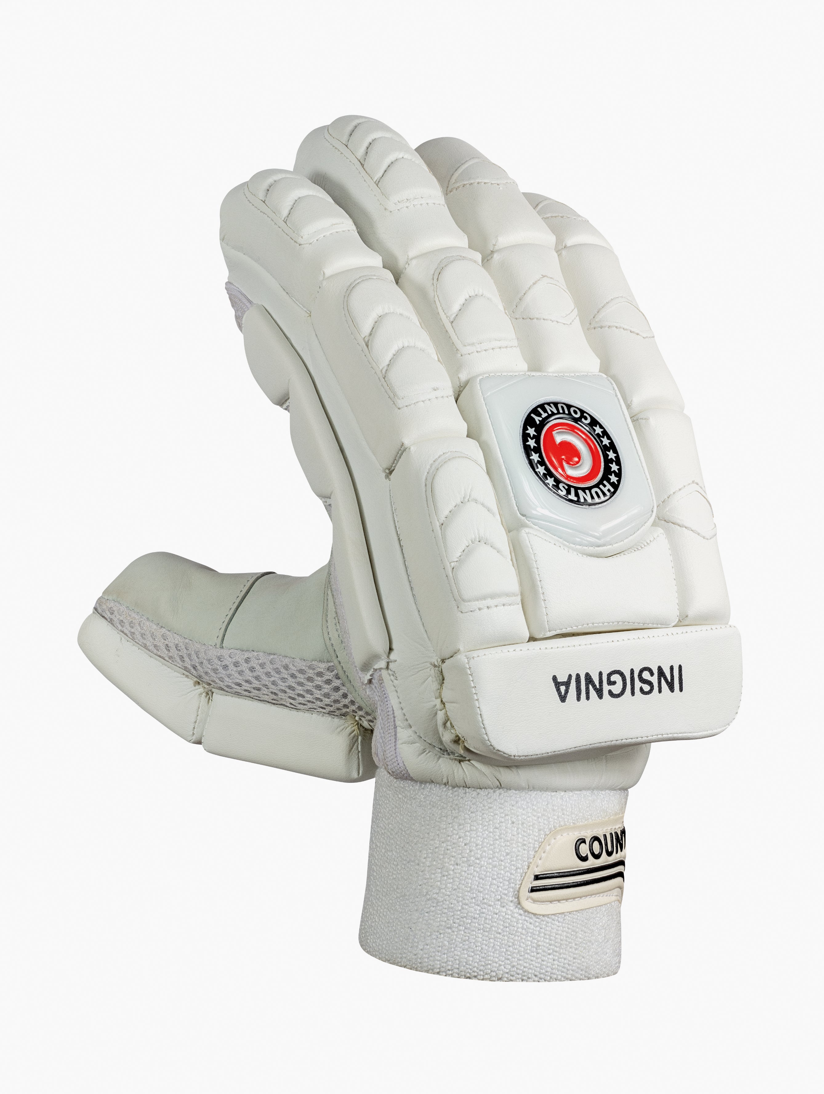 The Hunts County Insignia Batting Gloves are white, made from premium leather with padded fingers and knuckles for protection. They feature a black and red COUNTYS INSIGNIA logo on the back and 'INSIGNIA' near the wrist strap.