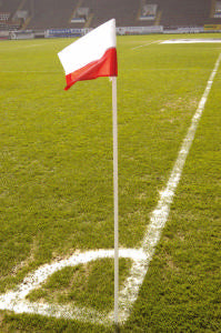 The Precision Training Precision Corner Posts (Pack of Four) mark the corner area on the green soccer field with weatherproof, flexible red and white posts and crisp painted lines at the intersection of end line and sideline.
