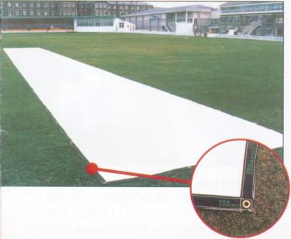 A Stuart Canvas Flatlay Lightweight Pitch Cover (25m x 6m) protects the cricket pitch, with a close-up showing a corner of the sheet and its metal ring used for ground securing.