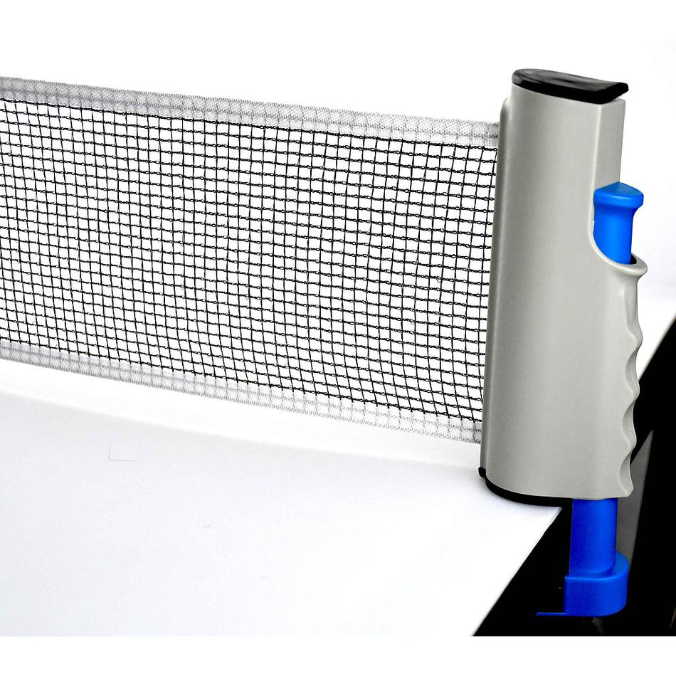 A close-up of the FoxTT Fox TT Retractable Table Tennis Net with black and white mesh, secured to a white table by a gray and blue clamp—an essential portable net from FoxTT for any table tennis setup.